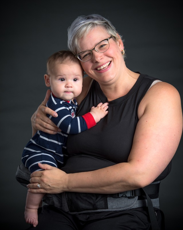 Lauren Kelly, owner of Music in Motion, holding a baby