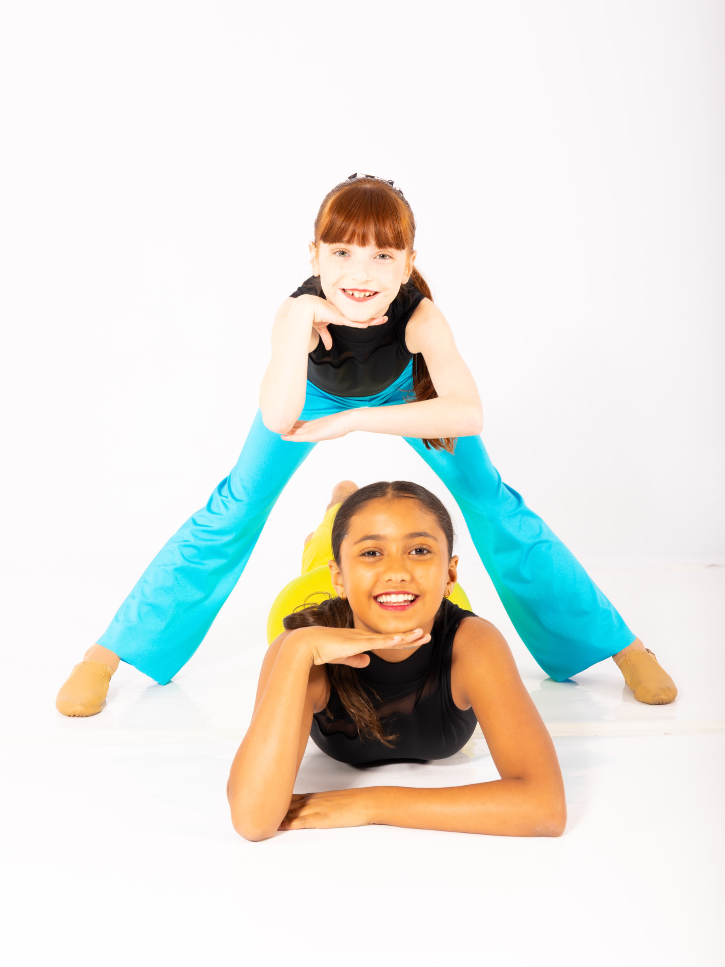 Three teen dancers posing together in the studio