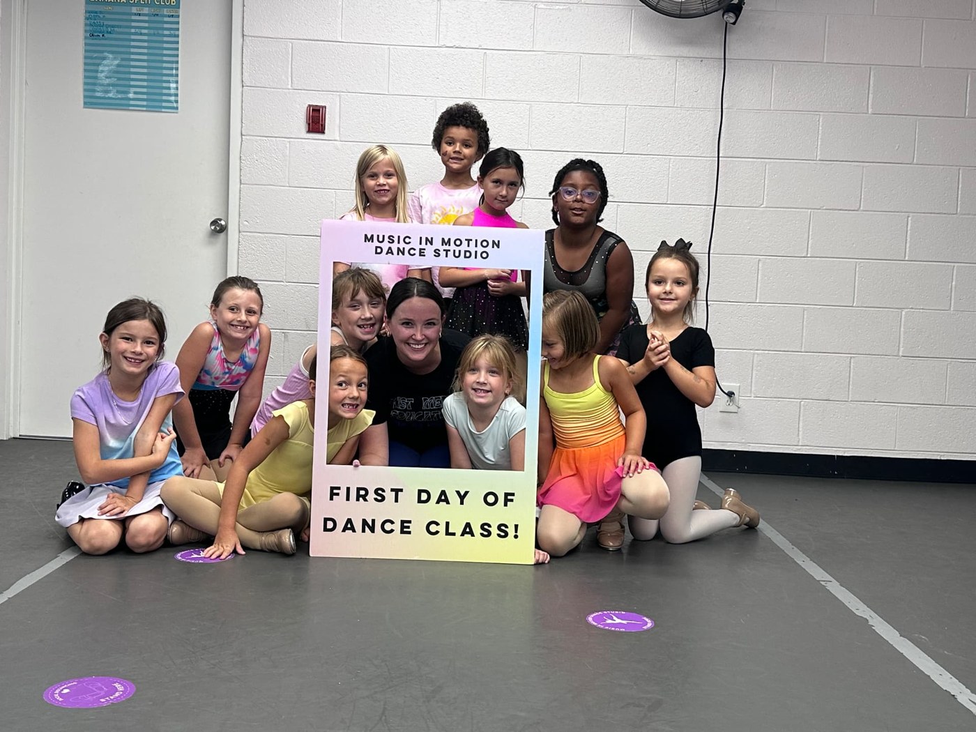 Students and their teacher celebrating their first day of dance class