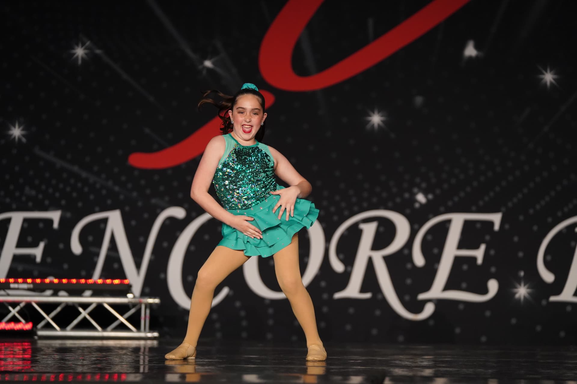 A Music in Motion dancer performing on stage in costume
