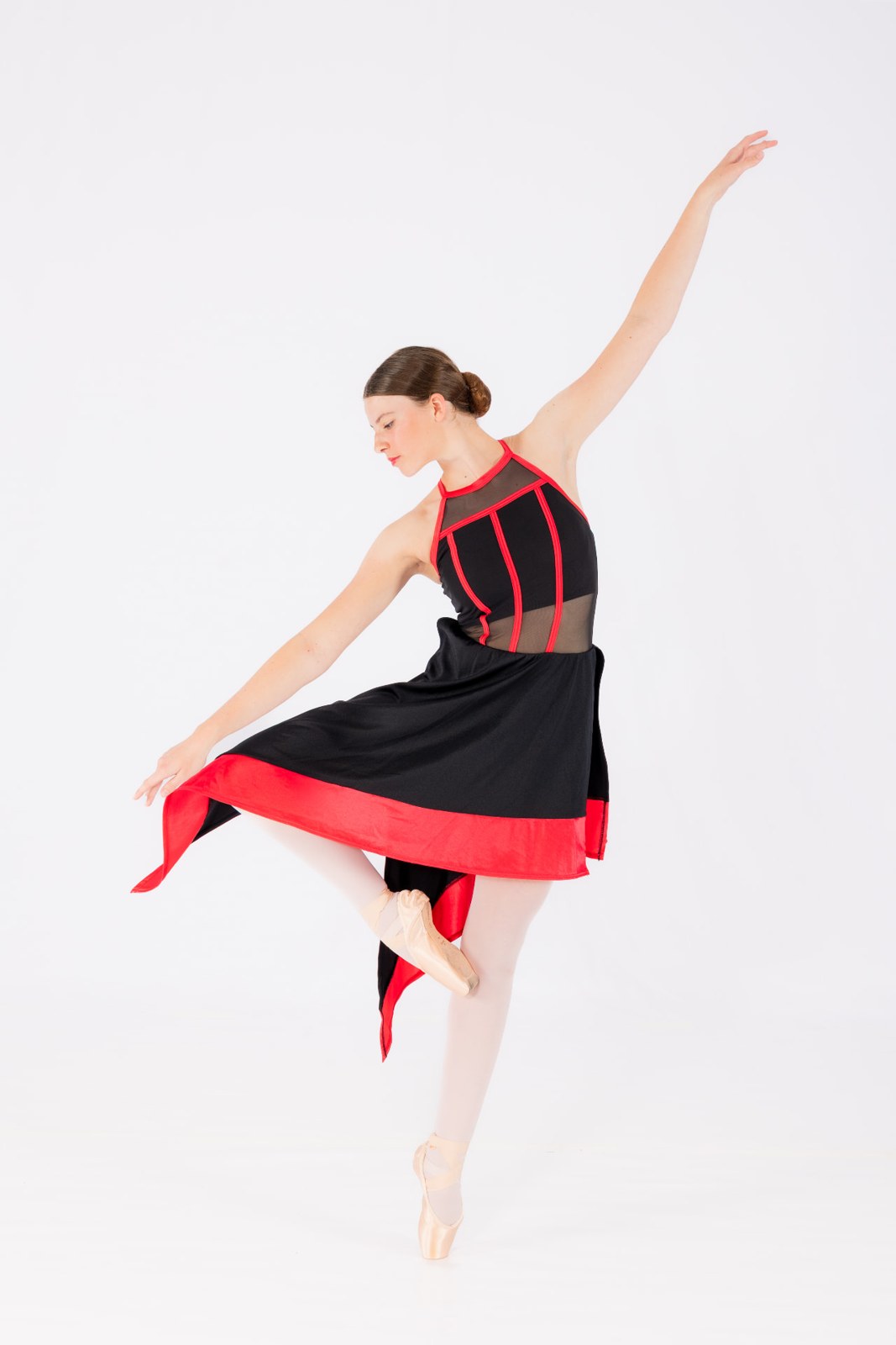 A dancer en pointe in a black and red costume