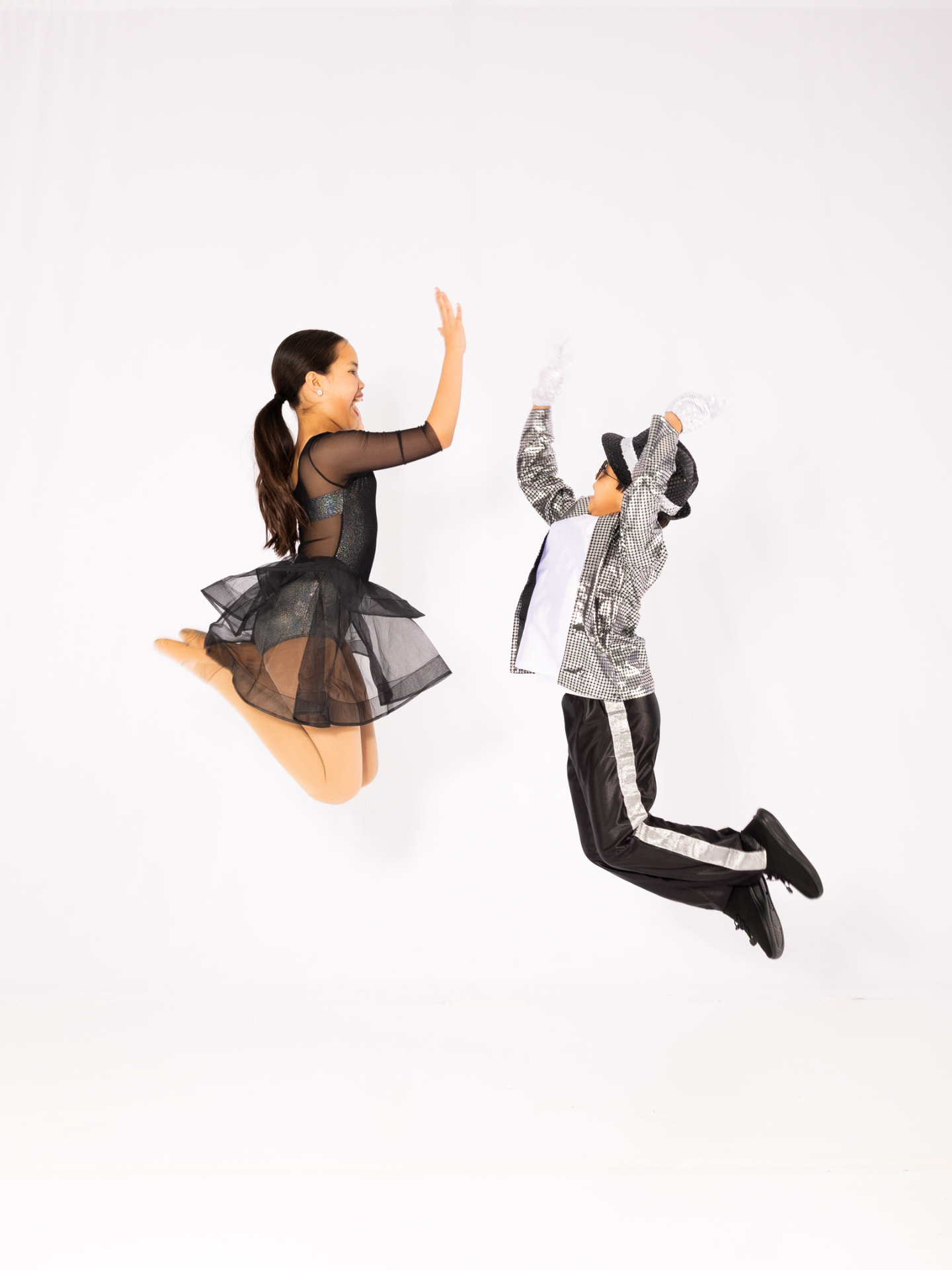 Two dancers jumping together in costume