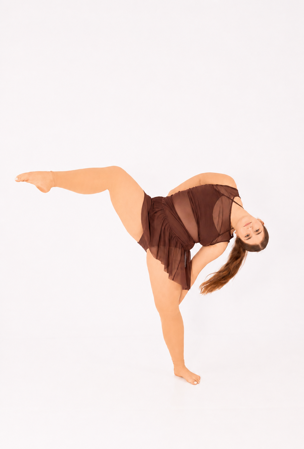 A Music in Motion contemporary dancer arching backward in the studio