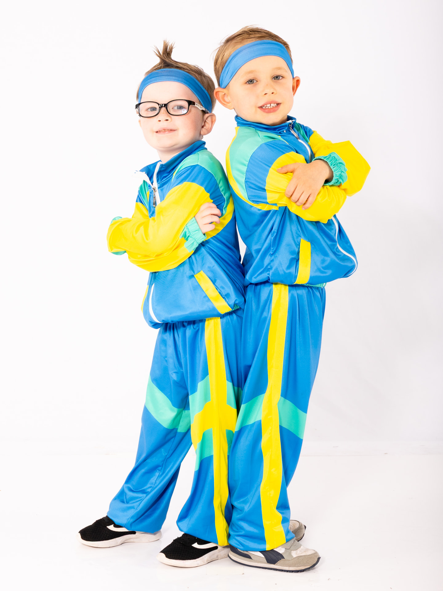Two young boys in blue tracksuits ready to dance