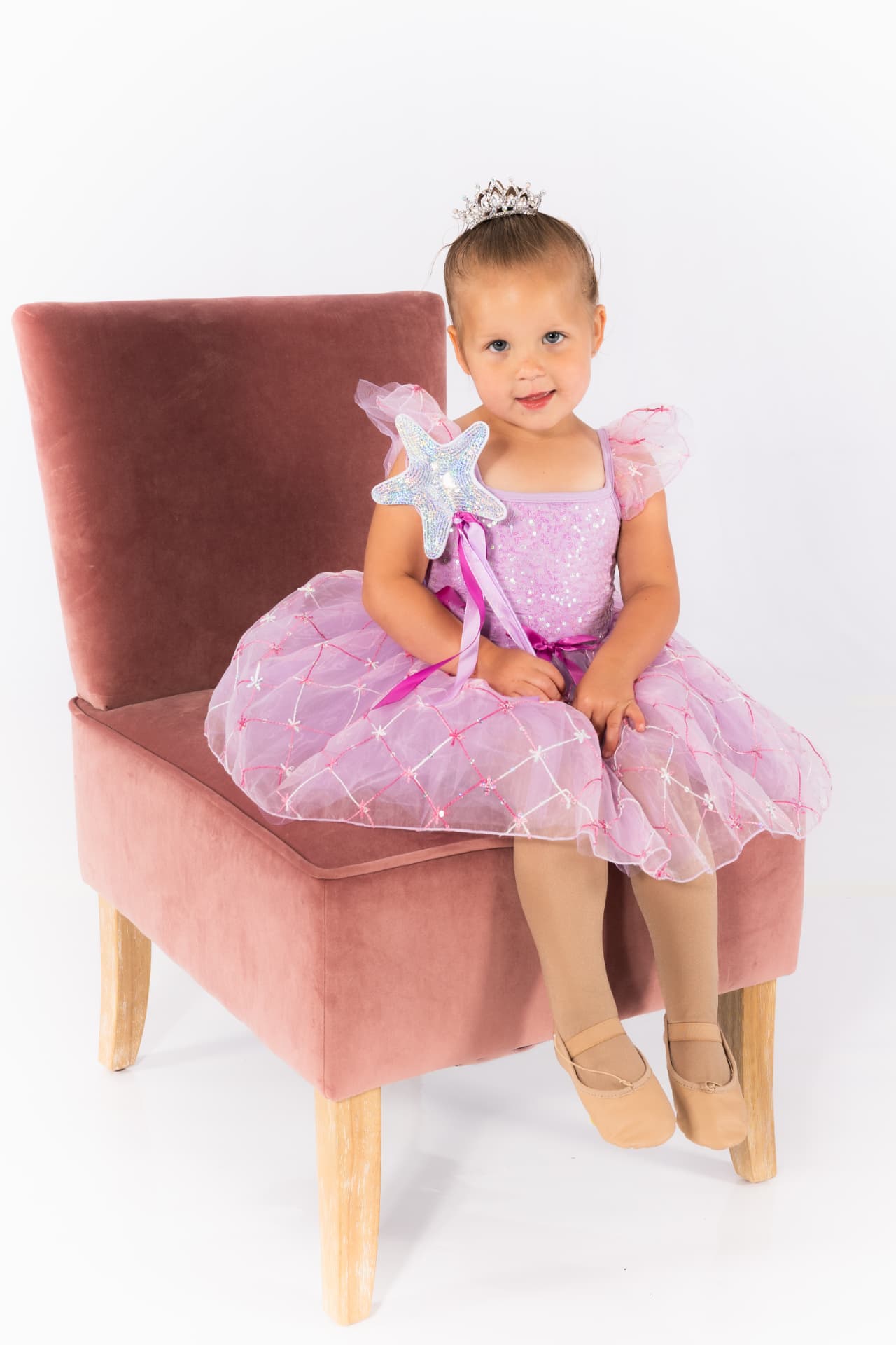 A preschool dancer in a lavender tutu holding a star wand