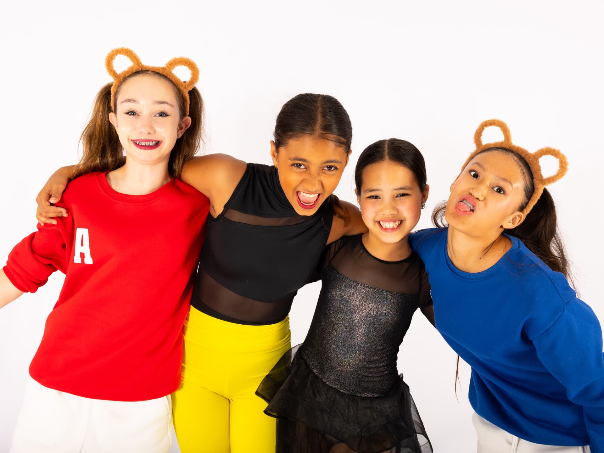 Four dancers in bear ear headbands arm in arm during Teddy Bear Week